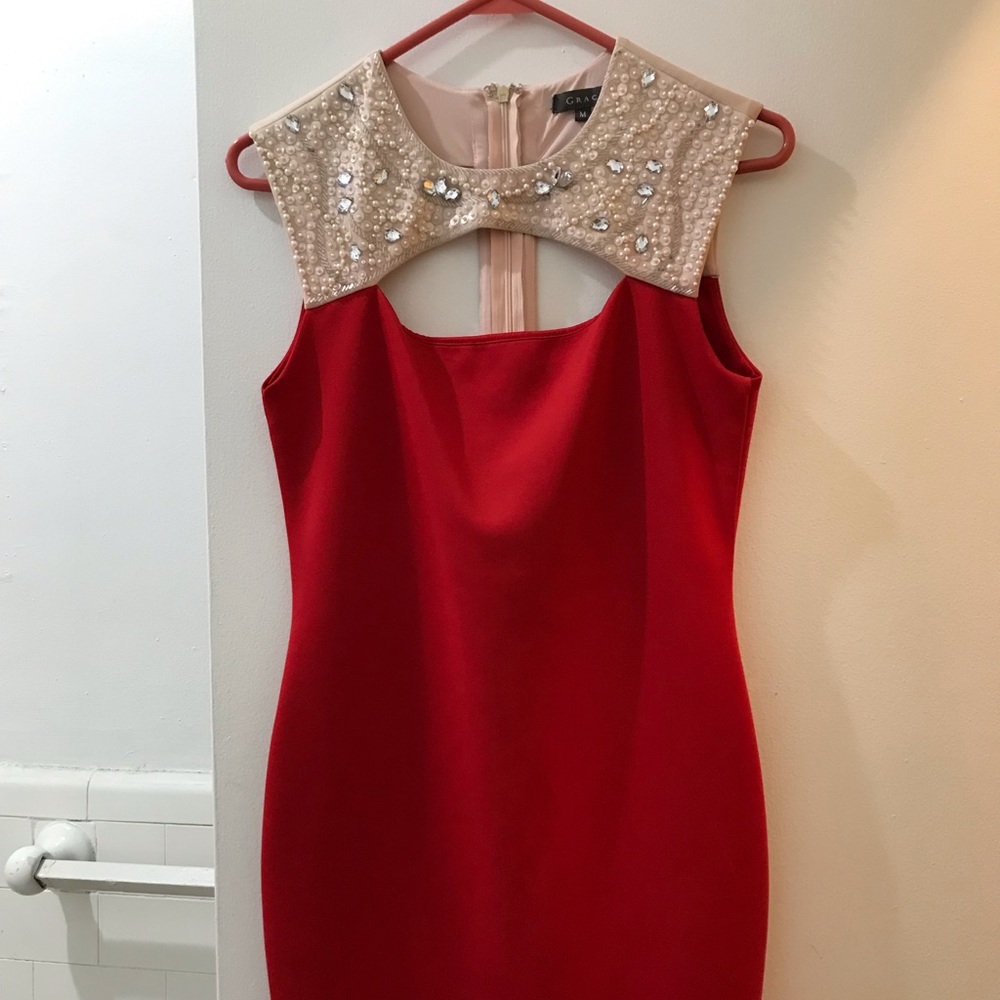 Gracia red mini dress with jeweled necklace detail.